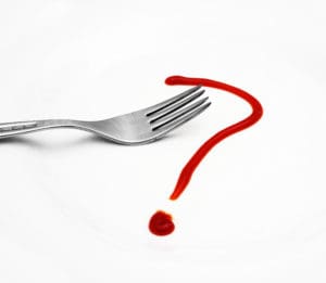 Red question mark on white plate with fork